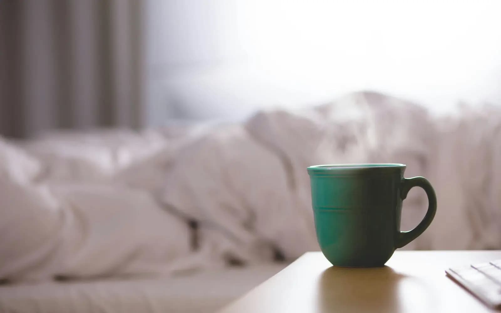 A ceramic mug resting on a tidy wooden desk